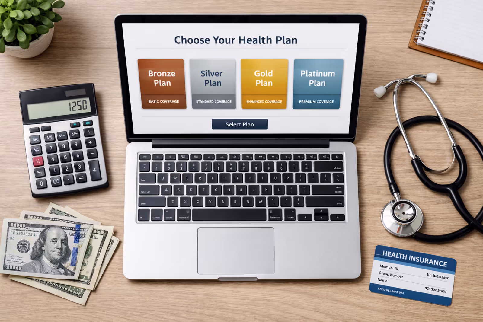 Top view of a desk with a laptop showing health insurance plan selection interface, calculator, stethoscope, dollar bills, and an insurance card